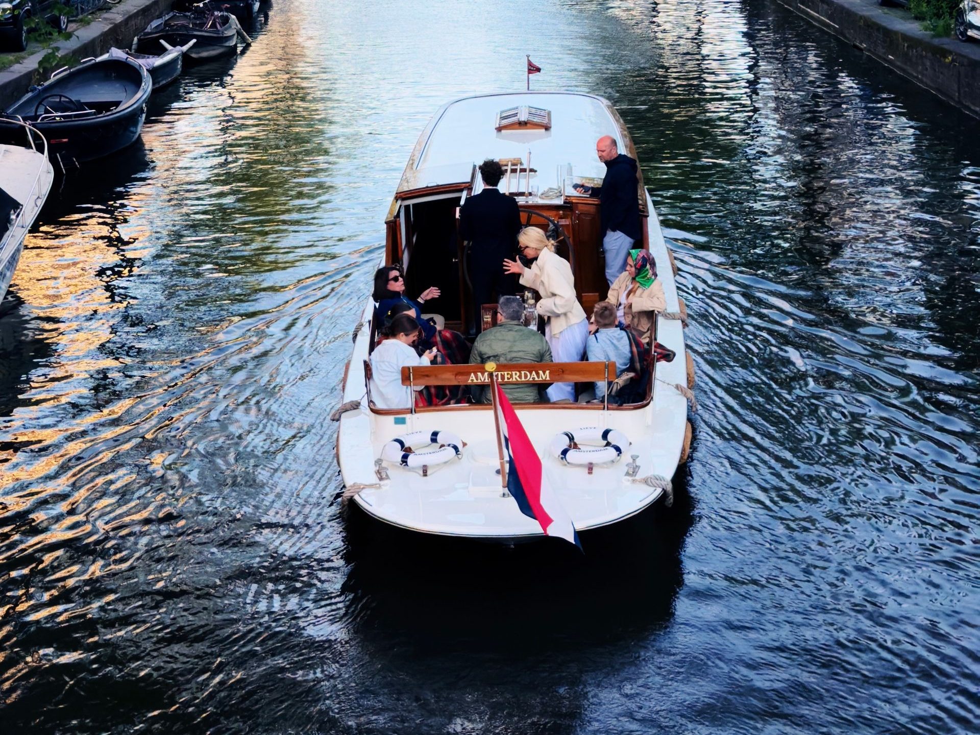 Discover the charm of Amsterdam's canals with a leisurely boat ride, capturing urban beauty.