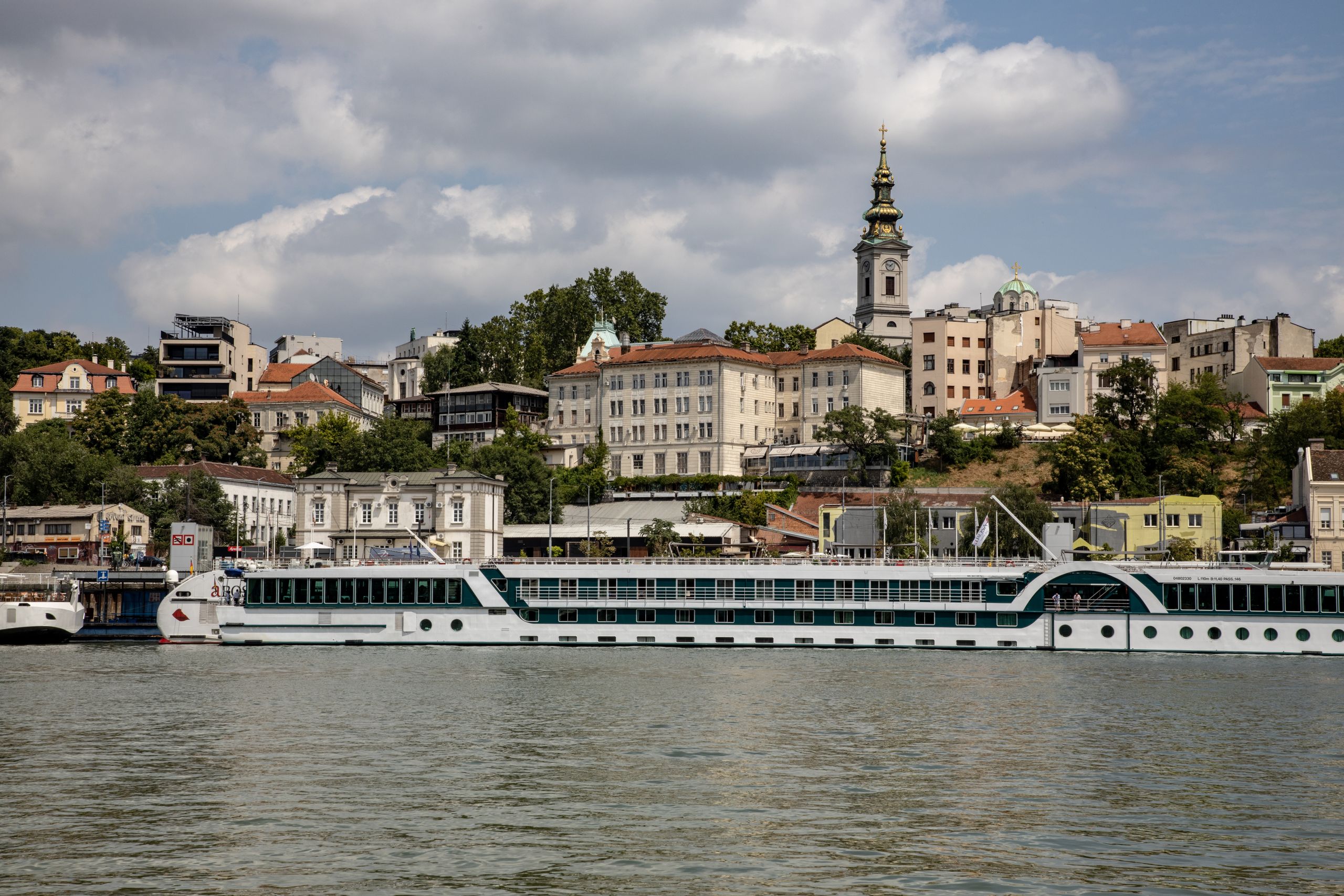 Picturesque Belgrade skyline along the River Sava with historic buildings and cruise ship.